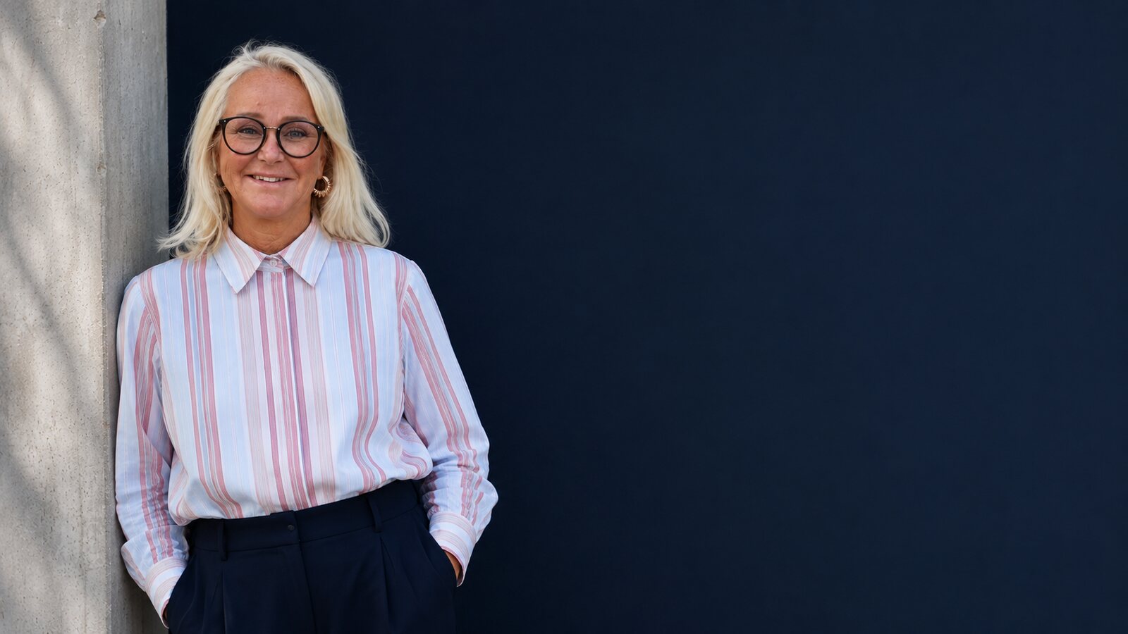 Torun Nordskaug lent mot en marineblå vegg